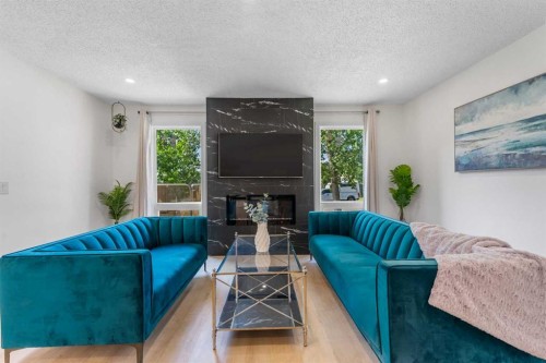 966 Berkley Drive Nw, Calgary, AB - Indoor Photo Showing Living Room With Fireplace