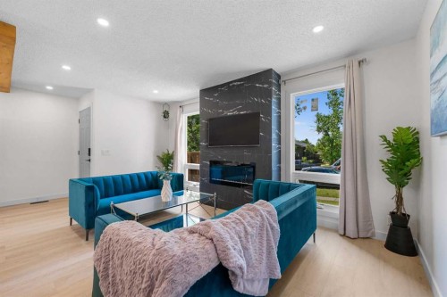 966 Berkley Drive Nw, Calgary, AB - Indoor Photo Showing Living Room With Fireplace