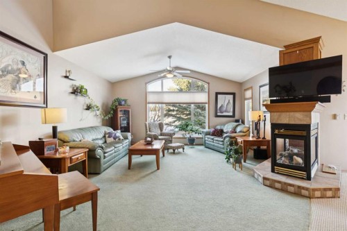 123 Whispering Way, Vulcan, AB - Indoor Photo Showing Living Room With Fireplace