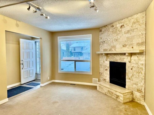 439 Ranchview Court Nw, Calgary, AB - Indoor Photo Showing Other Room With Fireplace