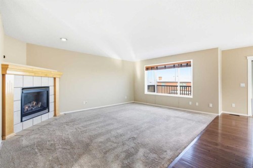 202 Panamount Court Nw, Calgary, AB - Indoor Photo Showing Living Room With Fireplace