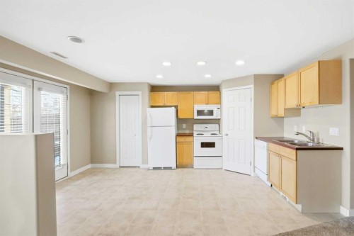 202 Panamount Court Nw, Calgary, AB - Indoor Photo Showing Kitchen With Double Sink