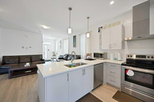 117 South Point Sw, Airdrie, AB - Indoor Photo Showing Kitchen With Double Sink With Upgraded Kitchen