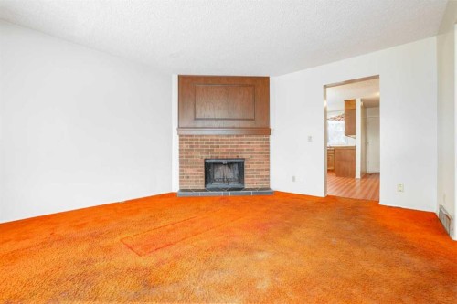 6404 24 Avenue Ne, Calgary, AB - Indoor Photo Showing Other Room With Fireplace
