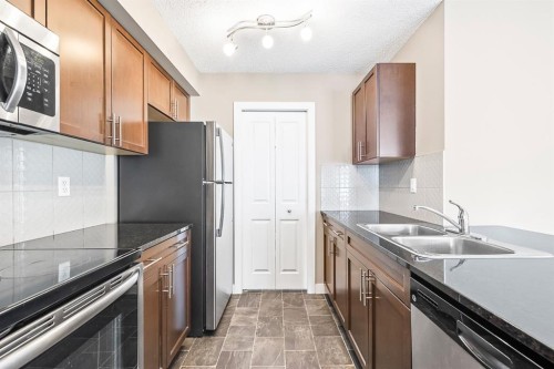 3108-625 Glenbow Drive, Cochrane, AB - Indoor Photo Showing Kitchen With Stainless Steel Kitchen With Double Sink