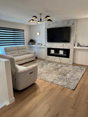 387 Templeview Drive Ne, Calgary, AB - Indoor Photo Showing Living Room With Fireplace