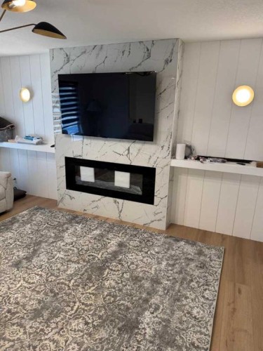 387 Templeview Drive Ne, Calgary, AB - Indoor Photo Showing Living Room With Fireplace
