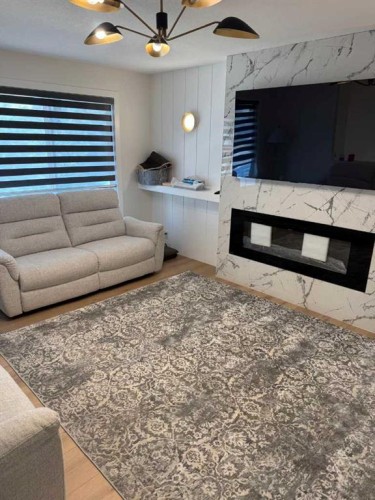 387 Templeview Drive Ne, Calgary, AB - Indoor Photo Showing Living Room With Fireplace