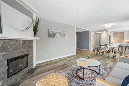 105-220 26 Avenue Sw, Calgary, AB - Indoor Photo Showing Living Room With Fireplace