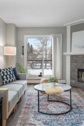 105-220 26 Avenue Sw, Calgary, AB - Indoor Photo Showing Living Room With Fireplace