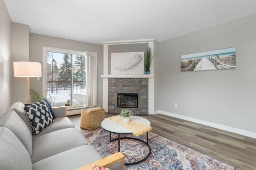 105-220 26 Avenue Sw, Calgary, AB - Indoor Photo Showing Living Room With Fireplace