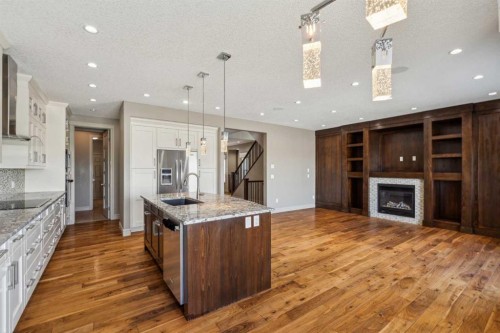 152 Evansborough Way Nw, Calgary, AB - Indoor Photo Showing Kitchen With Fireplace With Upgraded Kitchen
