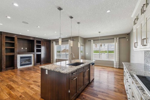 152 Evansborough Way Nw, Calgary, AB - Indoor Photo Showing Kitchen With Fireplace With Upgraded Kitchen