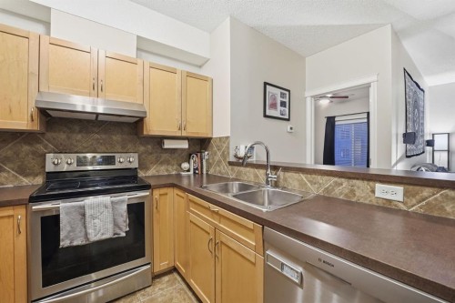 4311-70 Panamount Drive Nw, Calgary, AB - Indoor Photo Showing Kitchen With Stainless Steel Kitchen With Double Sink