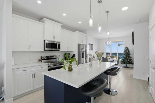 496 Reynolds Avenue Sw, Airdrie, AB - Indoor Photo Showing Kitchen With Stainless Steel Kitchen With Upgraded Kitchen