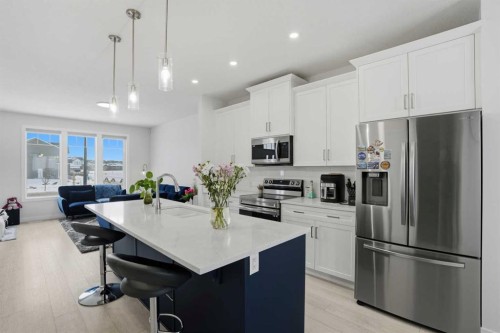 496 Reynolds Avenue Sw, Airdrie, AB - Indoor Photo Showing Kitchen With Stainless Steel Kitchen With Upgraded Kitchen