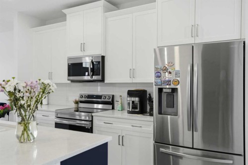 496 Reynolds Avenue Sw, Airdrie, AB - Indoor Photo Showing Kitchen With Stainless Steel Kitchen With Upgraded Kitchen
