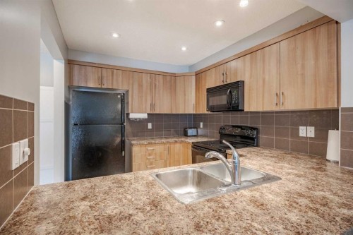 3098 Windsong Boulevard Sw, Airdrie, AB - Indoor Photo Showing Kitchen With Double Sink
