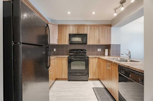 3098 Windsong Boulevard Sw, Airdrie, AB - Indoor Photo Showing Kitchen With Double Sink