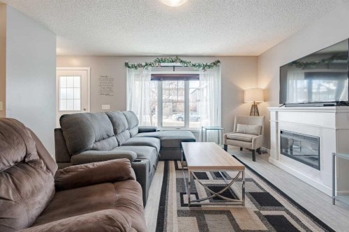 3098 Windsong Boulevard Sw, Airdrie, AB - Indoor Photo Showing Living Room With Fireplace