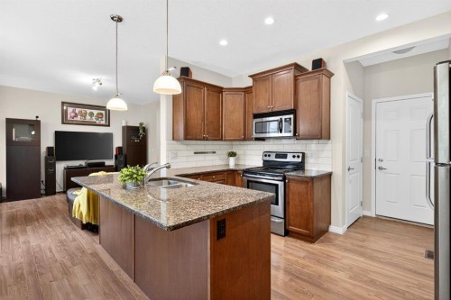 2002-1001 8 Street Nw, Airdrie, AB - Indoor Photo Showing Kitchen With Double Sink With Upgraded Kitchen