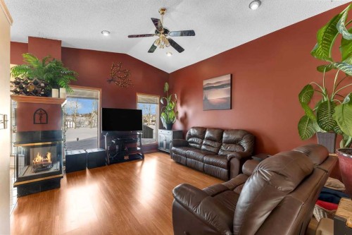 283058 Township Road 245A, Rural Rocky View County, AB - Indoor Photo Showing Living Room With Fireplace