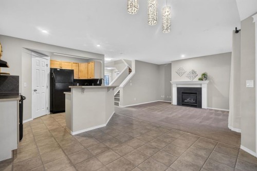 147 Everstone Rise Sw, Calgary, AB - Indoor Photo Showing Kitchen With Fireplace