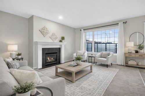147 Everstone Rise Sw, Calgary, AB - Indoor Photo Showing Living Room With Fireplace