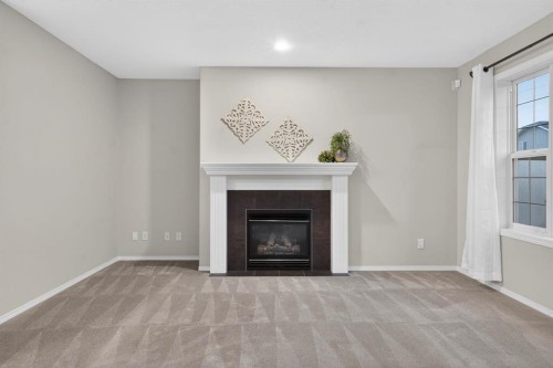 147 Everstone Rise Sw, Calgary, AB - Indoor Photo Showing Living Room With Fireplace