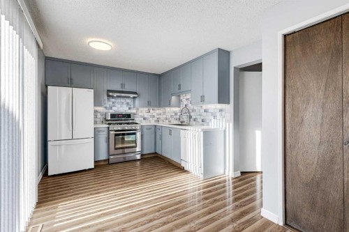 123 Woodsman Lane Sw, Calgary, AB - Indoor Photo Showing Kitchen With Upgraded Kitchen