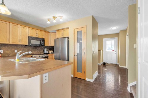 101-2384 Sagewood Gate Sw, Airdrie, AB - Indoor Photo Showing Kitchen With Double Sink
