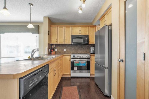 101-2384 Sagewood Gate Sw, Airdrie, AB - Indoor Photo Showing Kitchen With Double Sink