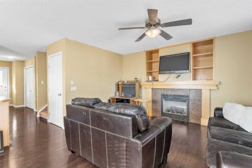 101-2384 Sagewood Gate Sw, Airdrie, AB - Indoor Photo Showing Living Room With Fireplace