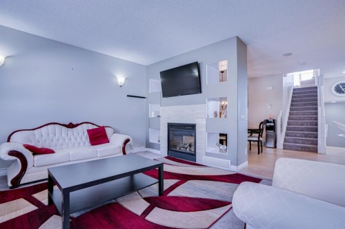 77 Saddleland Drive Ne, Calgary, AB - Indoor Photo Showing Living Room With Fireplace