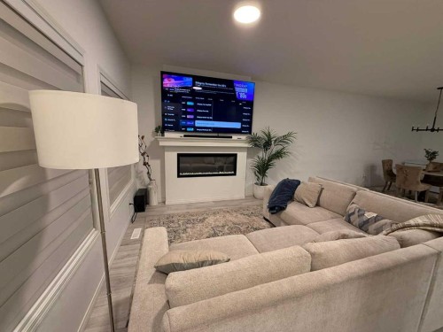 119 Edith Drive Nw, Calgary, AB - Indoor Photo Showing Living Room With Fireplace