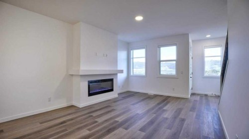 774 Wolf Willow Boulevard Se, Calgary, AB - Indoor Photo Showing Other Room With Fireplace