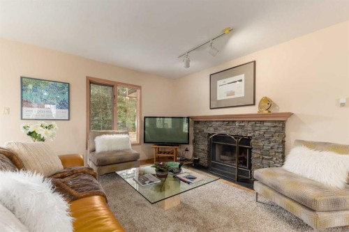 231031 Forestry Way, Bragg Creek, AB - Indoor Photo Showing Living Room With Fireplace