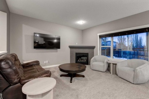 106 Silverado Skies Drive Sw, Calgary, AB - Indoor Photo Showing Living Room With Fireplace