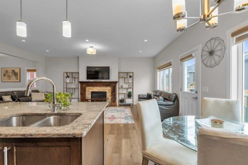 7672 80 Avenue Ne, Calgary, AB - Indoor Photo Showing Kitchen With Fireplace With Double Sink