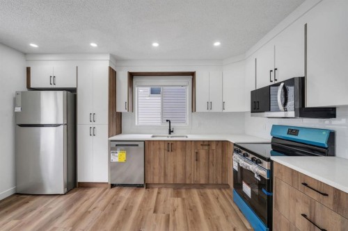 11 Hidden Valley Link Nw, Calgary, AB - Indoor Photo Showing Kitchen With Stainless Steel Kitchen With Double Sink