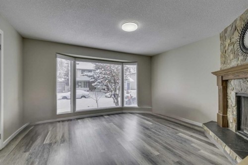 68 Woodglen Close Sw, Calgary, AB - Indoor With Fireplace
