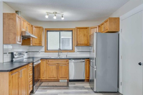 68 Woodglen Close Sw, Calgary, AB - Indoor Photo Showing Kitchen With Double Sink