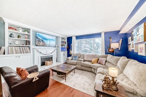 35 Macewan Drive Nw, Calgary, AB - Indoor Photo Showing Living Room With Fireplace