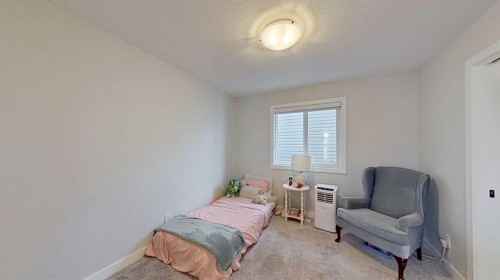 184 Emberside Place, Cochrane, AB - Indoor Photo Showing Bedroom