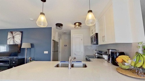 184 Emberside Place, Cochrane, AB - Indoor Photo Showing Kitchen With Double Sink