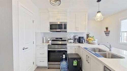 184 Emberside Place, Cochrane, AB - Indoor Photo Showing Kitchen With Double Sink