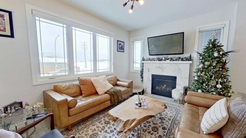 184 Emberside Place, Cochrane, AB - Indoor Photo Showing Living Room With Fireplace