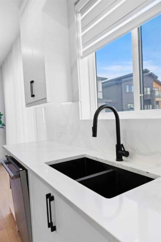 21 Sunvalley View, Cochrane, AB - Indoor Photo Showing Kitchen With Double Sink
