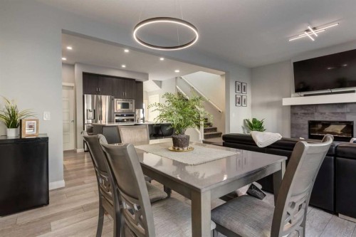 57 Evansfield Gate Nw, Calgary, AB - Indoor Photo Showing Dining Room With Fireplace