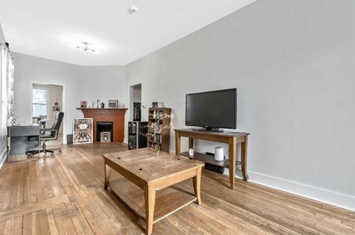 430 15 Avenue Ne, Calgary, AB - Indoor Photo Showing Other Room With Fireplace